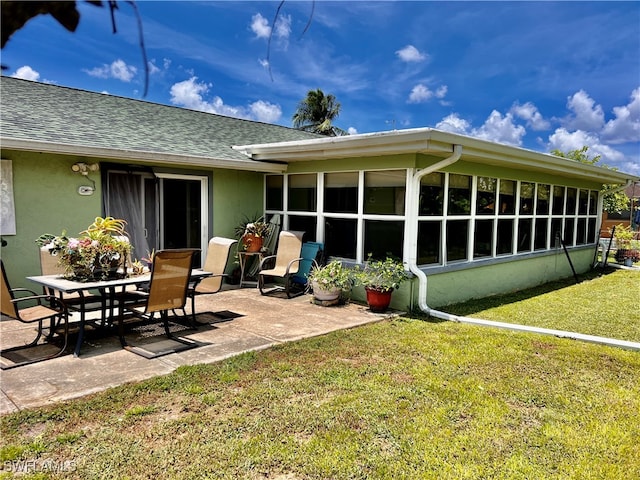 back of property with a patio area and a lawn