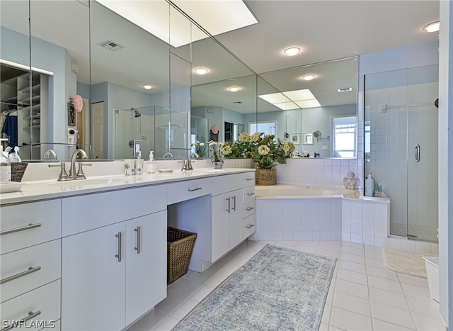 bathroom featuring shower with separate bathtub, tile patterned flooring, and double sink vanity