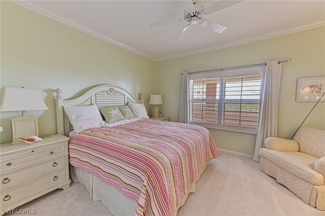 carpeted bedroom featuring ornamental molding and ceiling fan