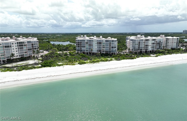 bird's eye view with a water view and a beach view