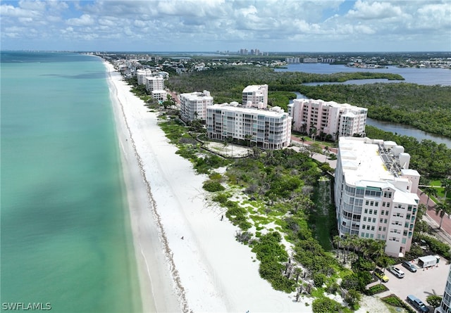 bird's eye view featuring a water view and a beach view