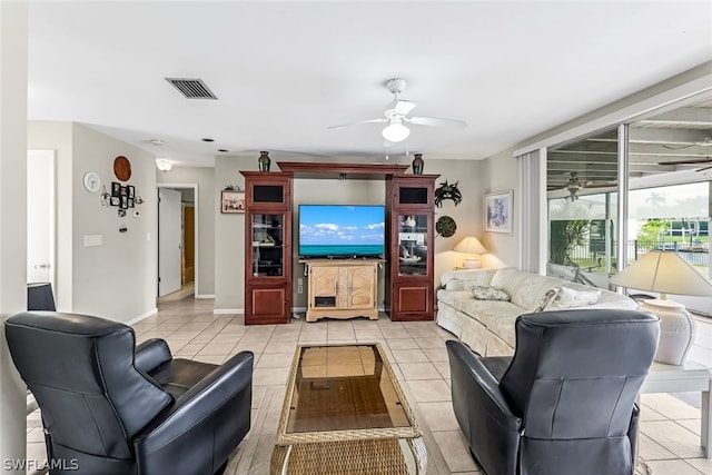 living room featuring ceiling fan and light tile patterned floors