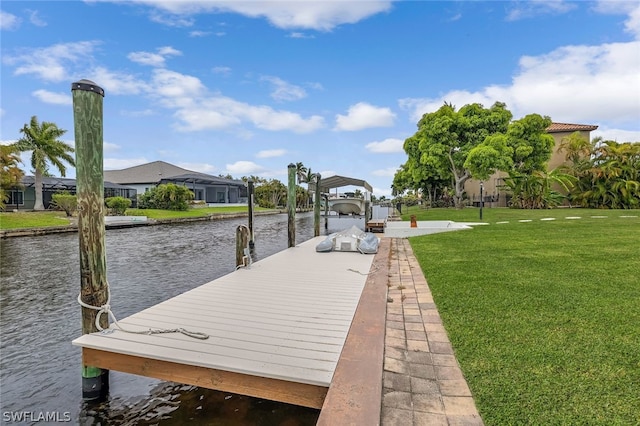 dock area with a yard and a water view