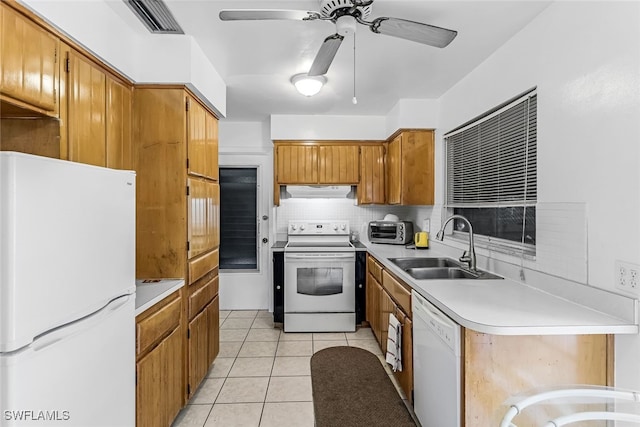 kitchen featuring white appliances, sink, ceiling fan, decorative backsplash, and light tile patterned floors