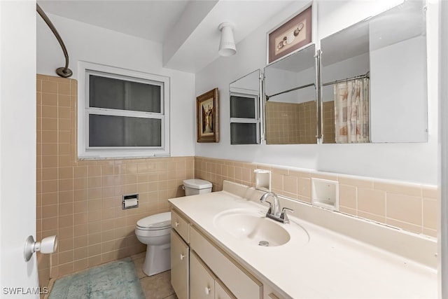 bathroom with walk in shower, tile patterned floors, toilet, vanity, and tile walls