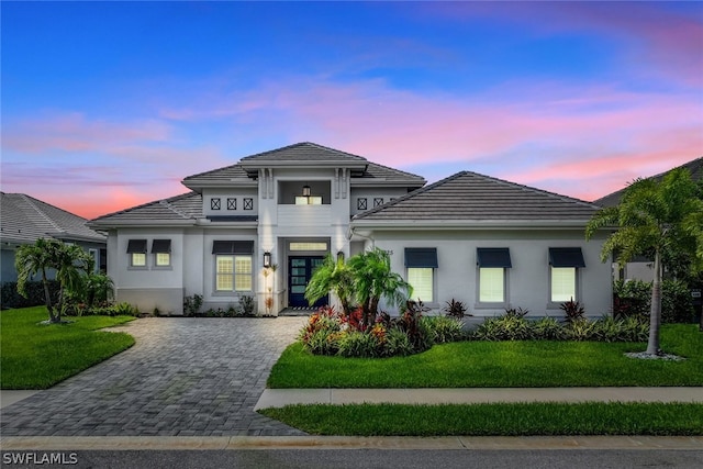 14225 Laguna Springs Ln, Naples, FL 34114 - view of front facade featuring a yard