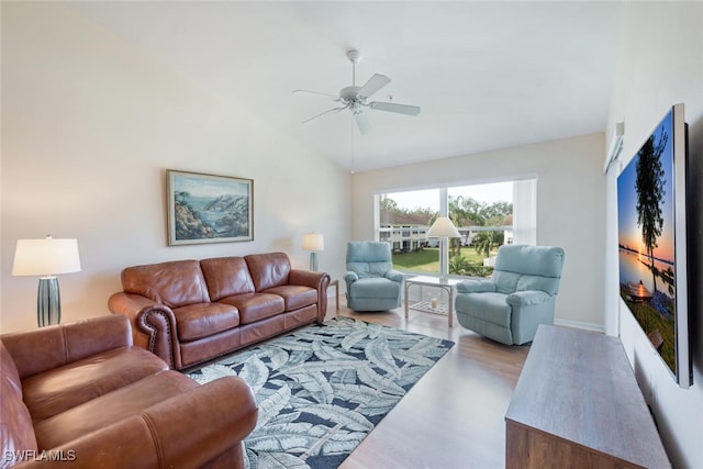 living room with vaulted ceiling, wood finished floors, and a ceiling fan