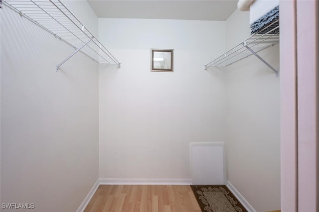 spacious closet with light wood finished floors