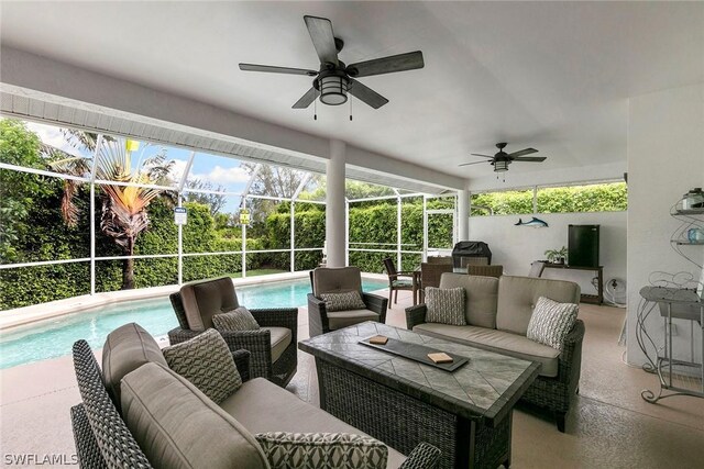 sunroom featuring ceiling fan and a swimming pool