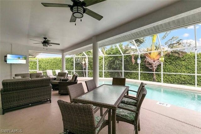 view of patio / terrace featuring an outdoor hangout area, glass enclosure, and ceiling fan