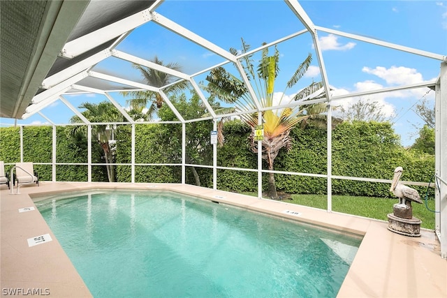 view of swimming pool with a lanai