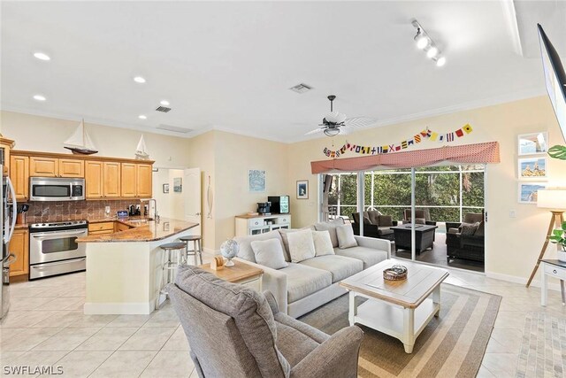 living room with ceiling fan, sink, crown molding, and light tile floors