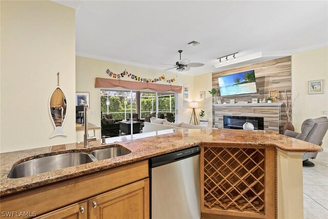 kitchen with dishwasher, ceiling fan, light tile floors, and stone countertops