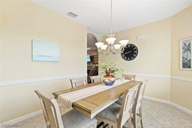 dining area with a notable chandelier and light tile floors