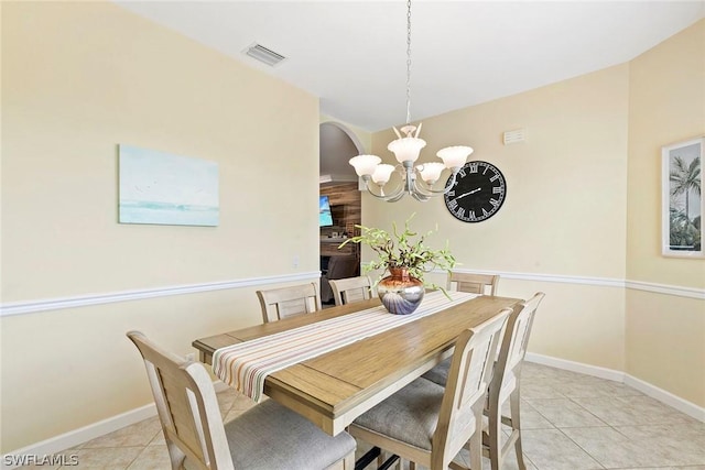 dining space with light tile patterned floors, visible vents, baseboards, and an inviting chandelier