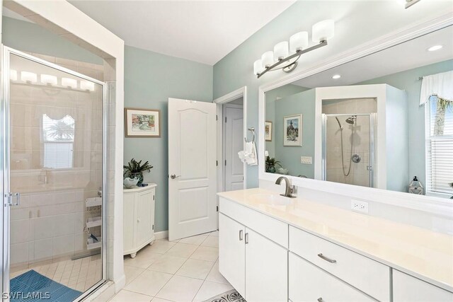 bathroom with walk in shower, vanity, and tile floors