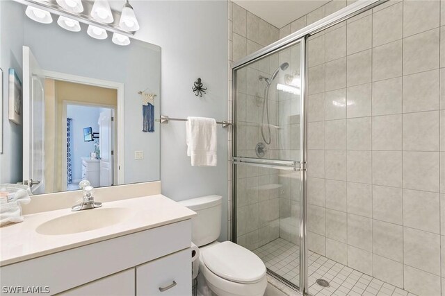 bathroom featuring oversized vanity, toilet, and walk in shower