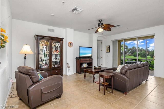 tiled living room with ceiling fan