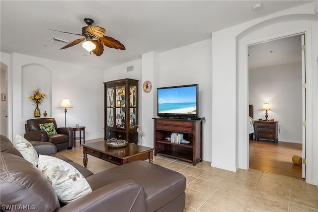 living room featuring light tile patterned floors and ceiling fan