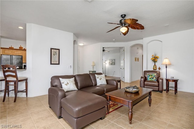 living room with ceiling fan and light tile patterned floors