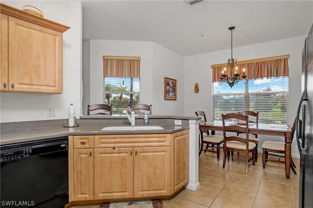 kitchen with plenty of natural light, sink, a notable chandelier, and black appliances