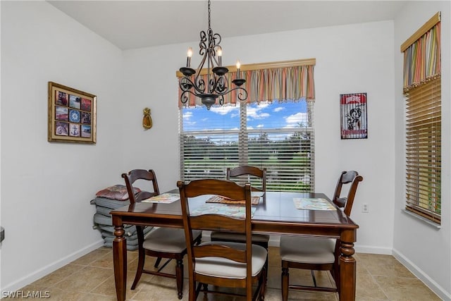 tiled dining area featuring a notable chandelier