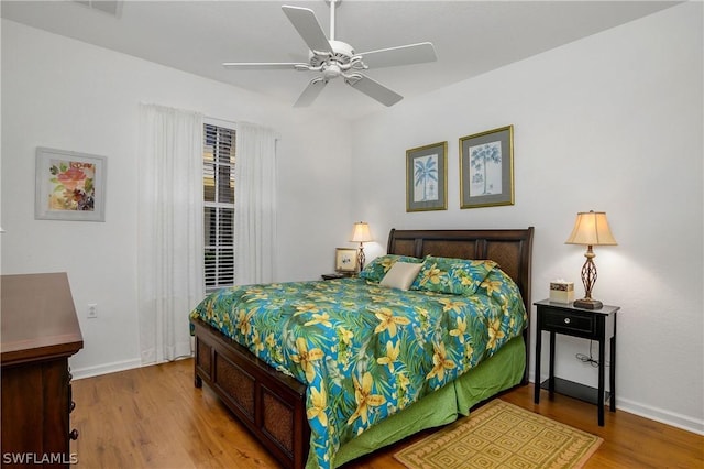 bedroom featuring hardwood / wood-style flooring and ceiling fan