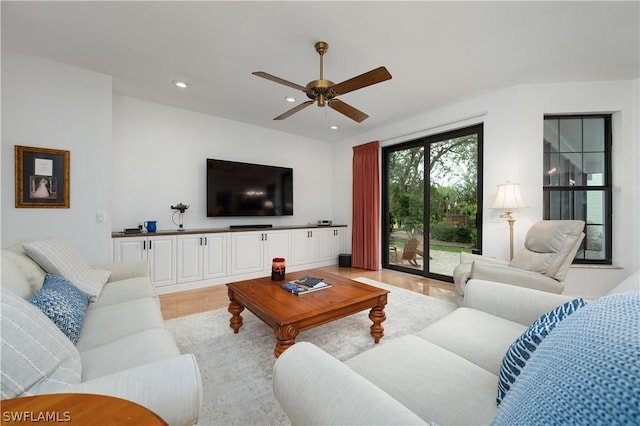 living room featuring light hardwood / wood-style floors and ceiling fan