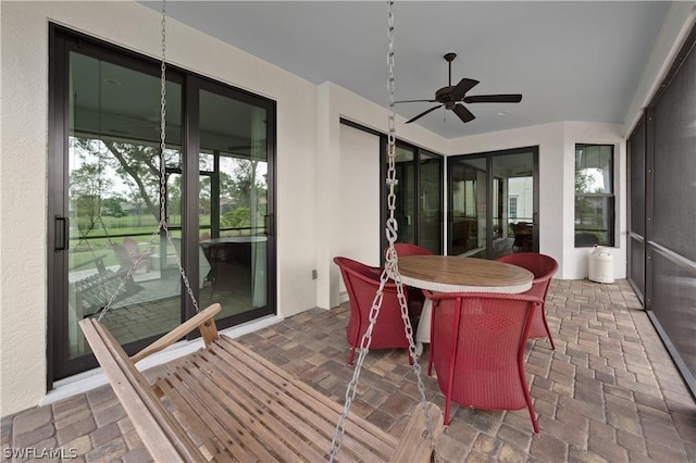 sunroom / solarium featuring ceiling fan