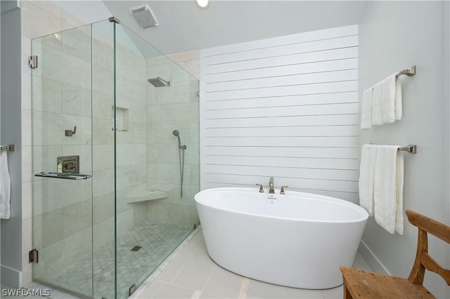 bathroom featuring tile patterned flooring and separate shower and tub