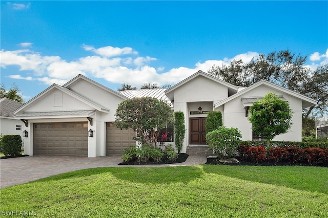 view of front of property featuring a garage and a front lawn