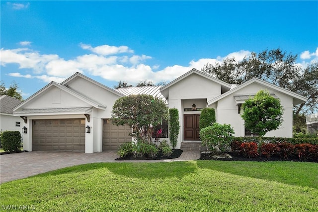 view of front of property featuring a garage and a front yard