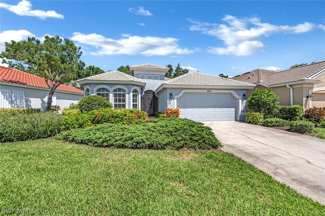 mediterranean / spanish home featuring a garage and a front lawn