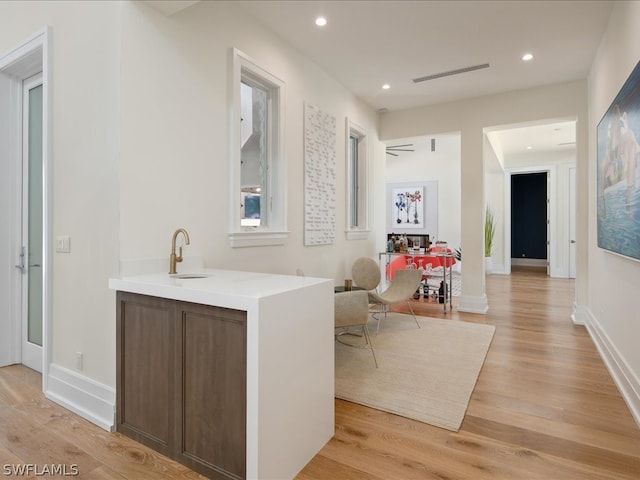 hallway featuring light hardwood / wood-style floors and sink