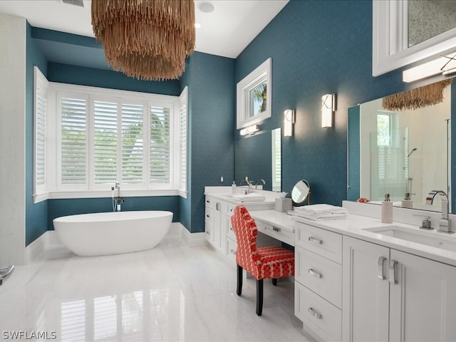 bathroom with vanity, independent shower and bath, and a wealth of natural light