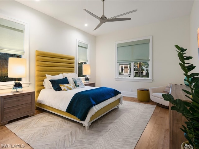 bedroom with ceiling fan and light wood-type flooring