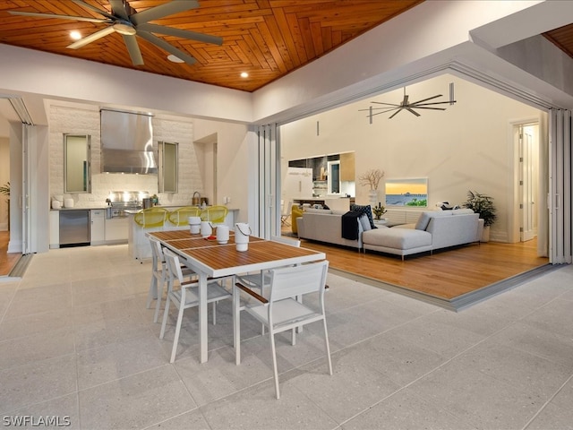 dining room with wood ceiling, light hardwood / wood-style flooring, a high ceiling, and ceiling fan