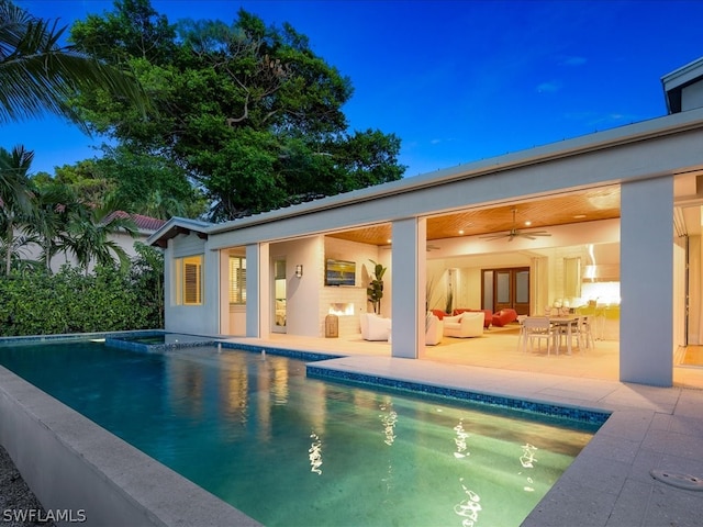 view of swimming pool with a patio and ceiling fan