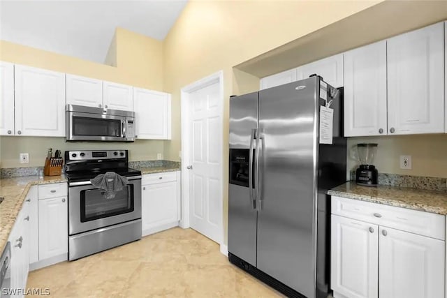 kitchen featuring light stone countertops, white cabinetry, and stainless steel appliances