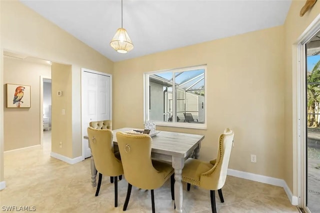 dining room featuring vaulted ceiling