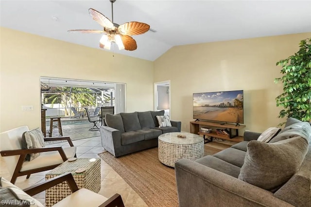 living room featuring ceiling fan, light tile patterned floors, and lofted ceiling