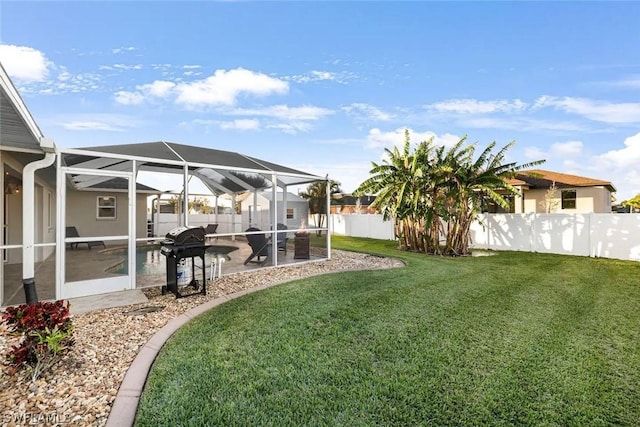 view of yard with glass enclosure, a patio area, and a swimming pool