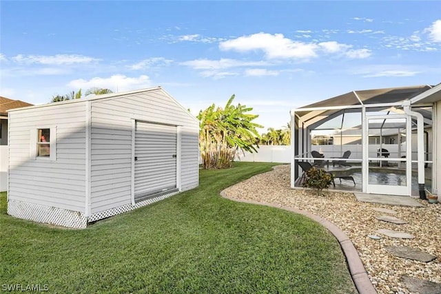 view of yard featuring a lanai, a patio, and a storage shed