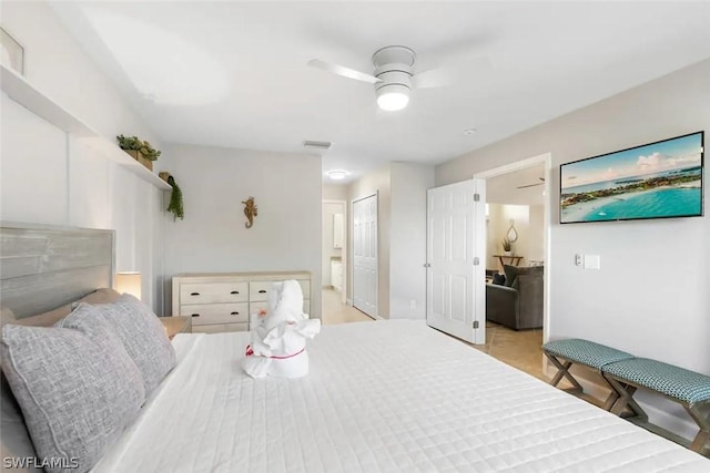 bedroom with connected bathroom, ceiling fan, and a closet