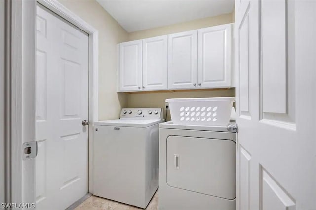 laundry room with cabinets and washing machine and dryer