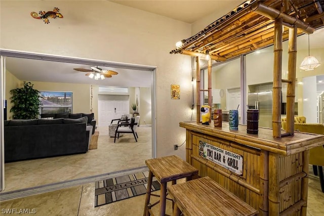 bar with pendant lighting and ceiling fan