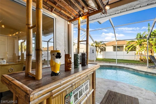 view of swimming pool with a lanai