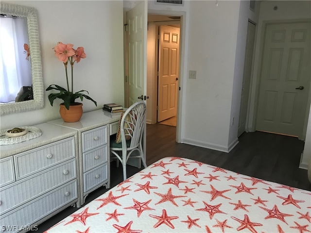 bedroom with dark hardwood / wood-style flooring