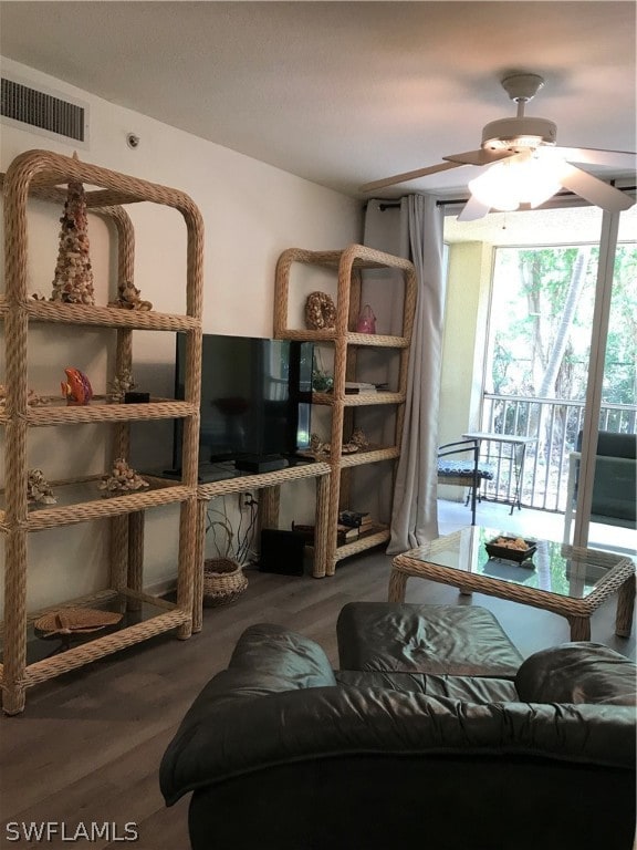 living room with ceiling fan and hardwood / wood-style floors