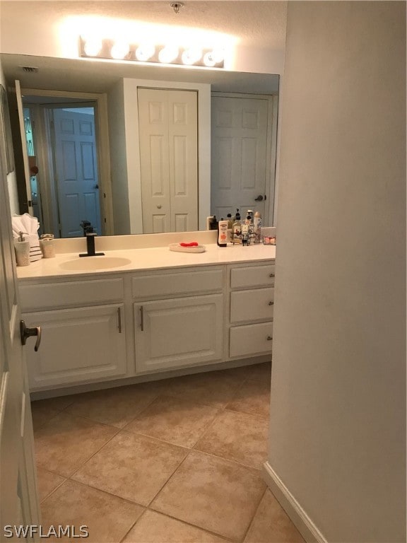 bathroom featuring tile floors and vanity